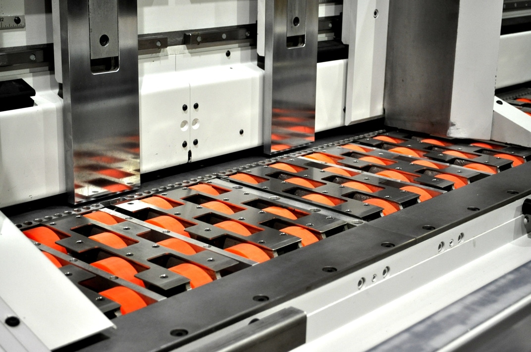 Conveyor system with orange rollers.